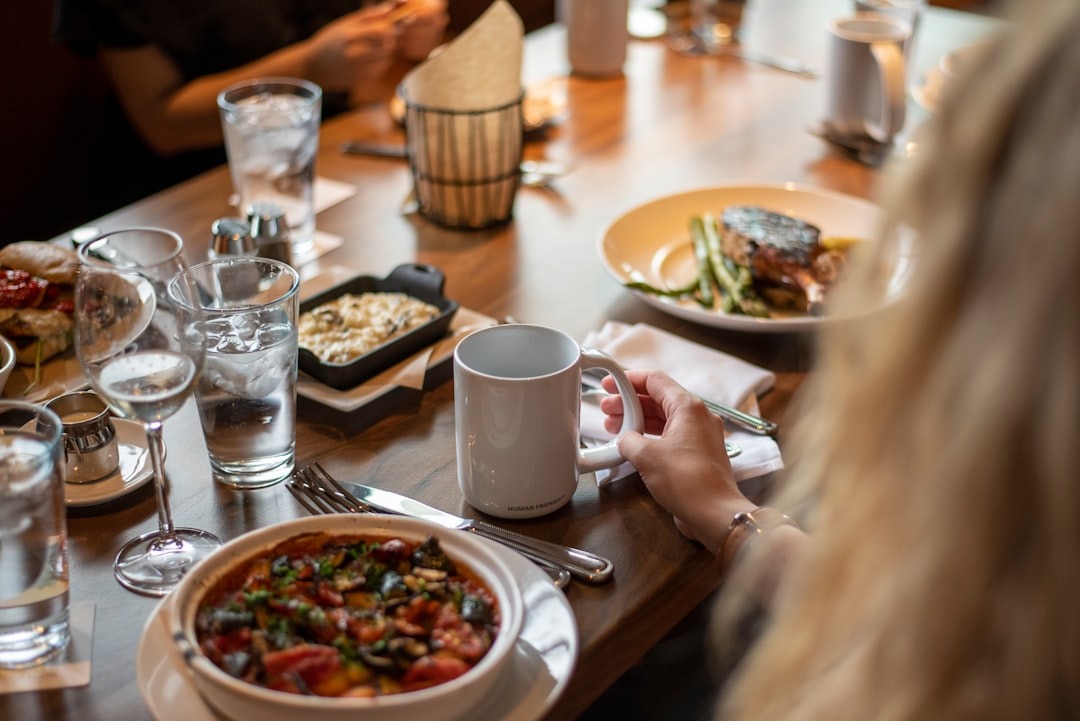 Diners enjoy a meal with various dishes and drinks.
